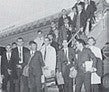 Several students standing on and near a staircase, posing for the camera