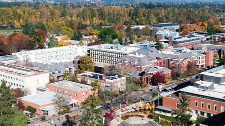 Aerial photo of the UO campus with mountains in the background