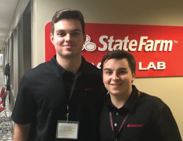 Leonardo Amatullo and Jake Gibson pose in front of the State Farm logo
