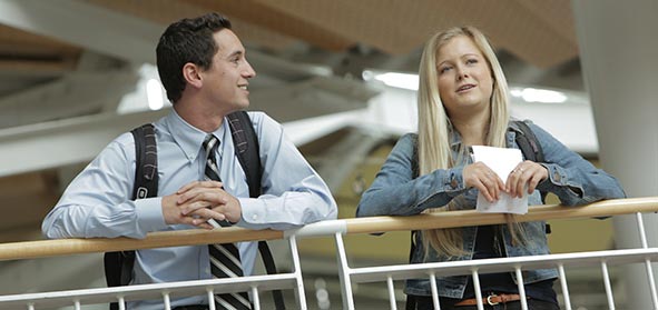Two students talk in the Lillis atrium