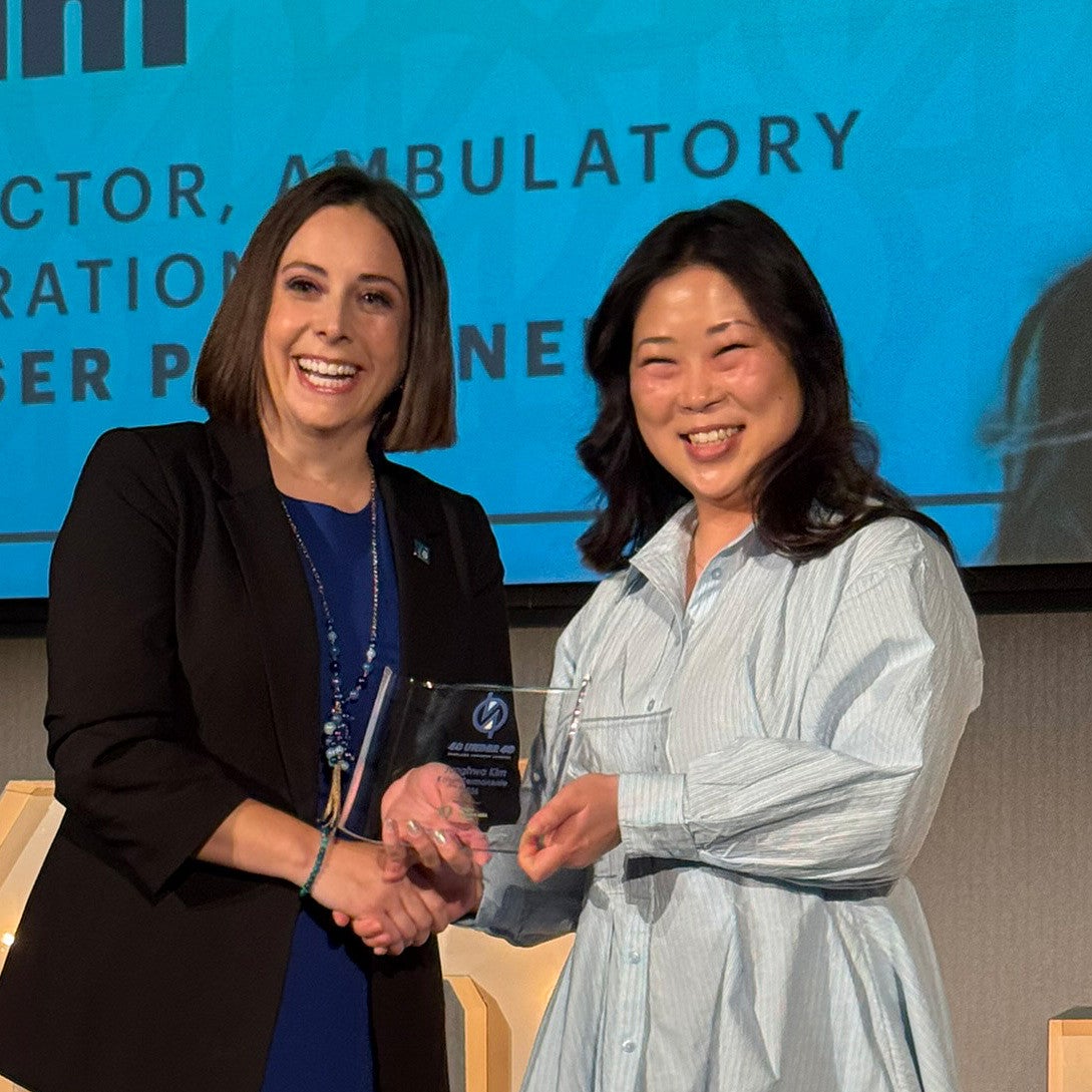 First-year Oregon Executive MBA student Junghwa Kim receives her award at Portland Business Journal's 40 under 40 luncheon.