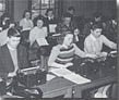 Several students sitting in rows of tables in 1957