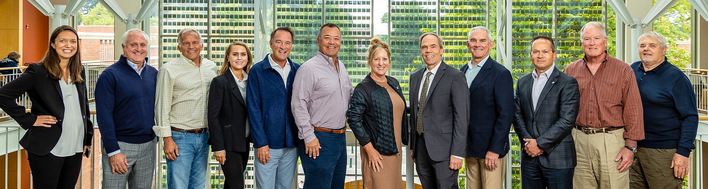 Lundquist College of Business's Board of Advisors standing in a line for a group photo.
