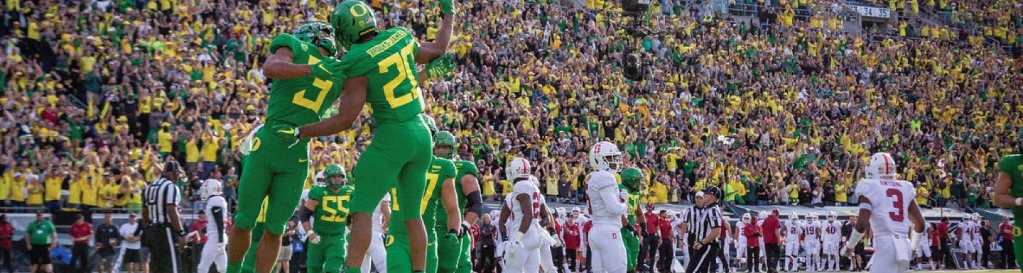 Two football players on the field at Autzen Stadium