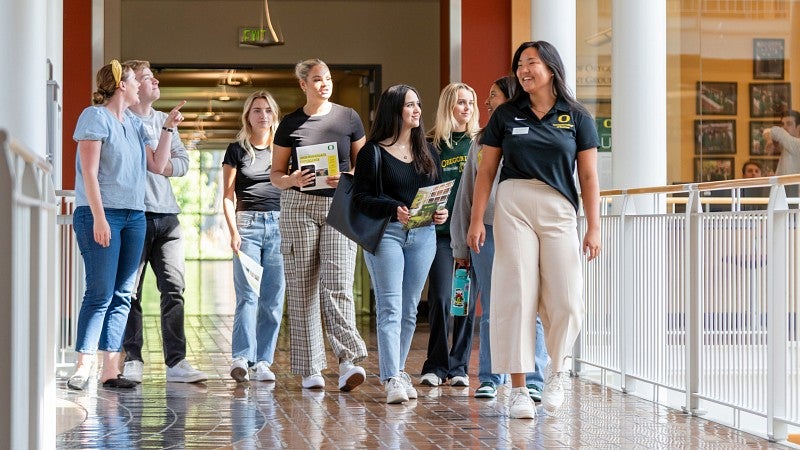 A group of students walking towards the camera and talking to each other.