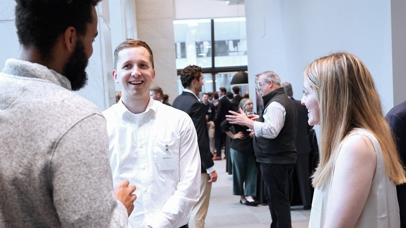 A room full of students networking with industry professionals.