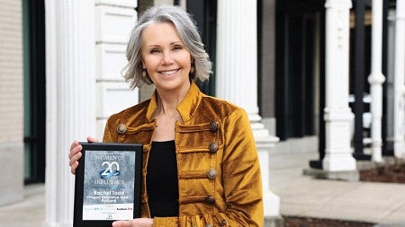 Rachel Todd holds up her 2023 Women of Influence award plaque