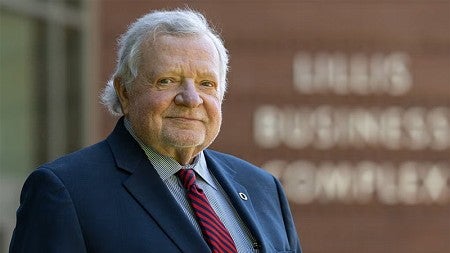 Chuck Lillis stands in front of the Lillis Business Complex