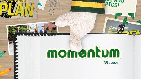 The hand of the UO Duck mascot points to a scrapbook page bearing the word "Momentum" and "Fall 2024"