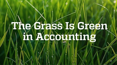 The text "The Grass is Green in Accounting" against a background of blades of grass