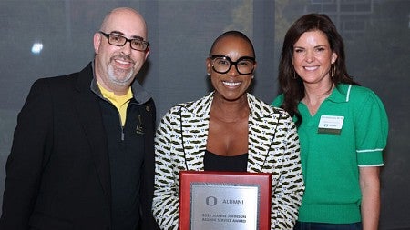 Ericka Warren (center) accepts the UO Alumni Association's 2024 Jeanne Johnson Alumni Service Award.