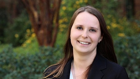 Adria Mankute head shot from shoulders and above wearing a suit