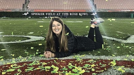 Julia Goldstein lies on the field at the Rose Bowl