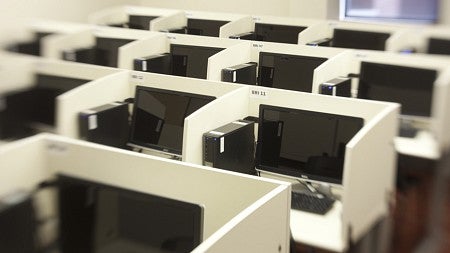 Close up on computer cubicles in the ESI studio showing them five across with dividers between them for privacy