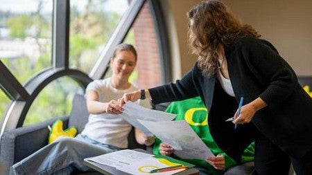 Faculty member showing students how to work a problem