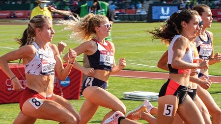 Athletes mid-stride during a track and field event