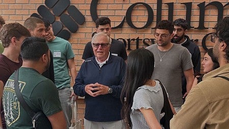 Tim Boyle of Columbia Sportswear, serving as a volunteer mentor at the V10 Builder Residency program, speaks to a crowd of young entrepreneurs