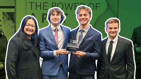 Photo of the four students on the Warsaw team holding their award against a background of the same students making their presentation