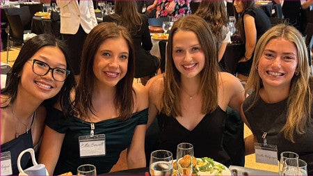 Student club members pose for a group photo while seated at a table during the 2025-2026 Dean's Council for Inter-Club Coordination End of Year Gala 