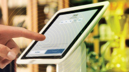 Close up photo of a customer entering information on a point of sale device