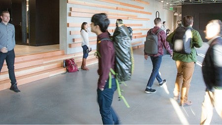 Students walking in the halls of the new Naito building