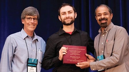 Brandon Reich receives his dissertation award