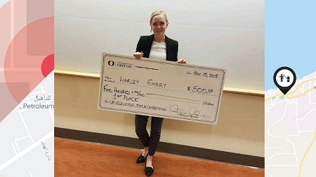 Averto cofounder Harley Emery poses with her award from an elevator competition