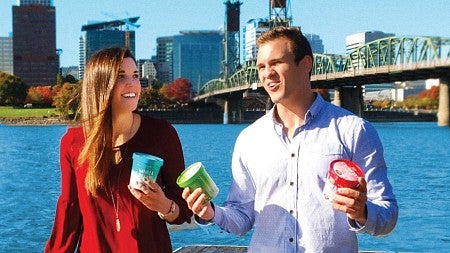 School of Accounting alumni hold their ice cream against a backdrop of Portland cityscape