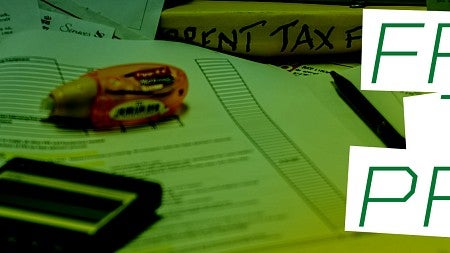"Free Tax Prep" against background of tax documents