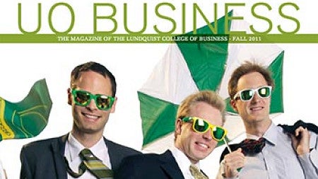 Cover of the issue featuring three men in suits being blown by the wind with ties flying, umbrellas inside out and flags waving, with the words "Going Full Blast"