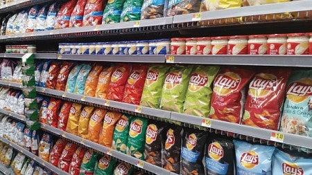 Rows of different brands of potato chips in a supermarket aisle