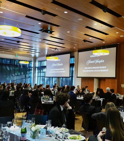Members of student organizations watch a speaker during an end-of-year gala