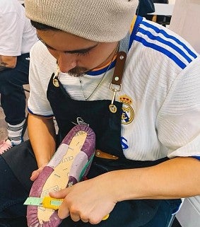 A student works on a shoe model