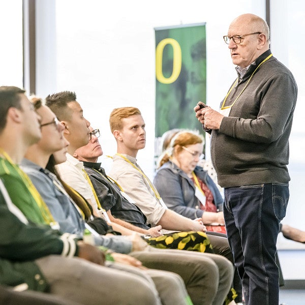 Audience of students sitting in rows looking at an industry professional speaking