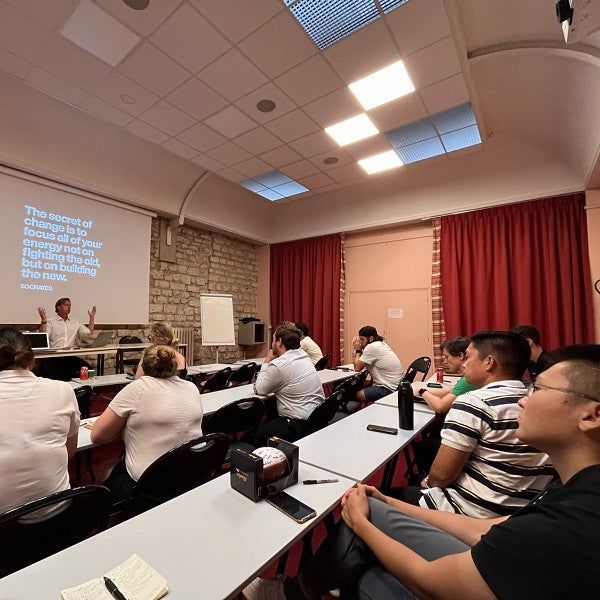 MBA students seated in a classroom, listening to a presentation.