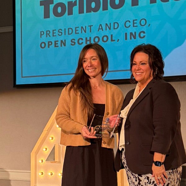 Christine Toribio Pitts, PhD '18, receives her award onstage at Portland Business Journal's 40 under 40 luncheon.