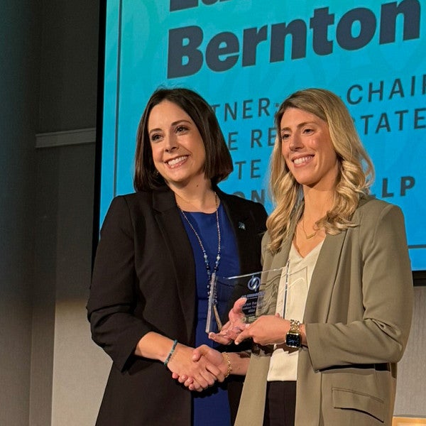 Lauren Bernton, JD '16, receives the 40 under 40 award onstage at Portland Business Journal's awards luncheon. 
