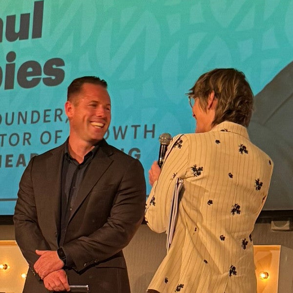 UO College of Design 2009 graduate Paul Spies is interviewed onstage during Portland Business Journal's 40 under 40 awards luncheon.