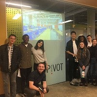 Members of the Net Impact group pose for a group photo in Pivot's headquarters